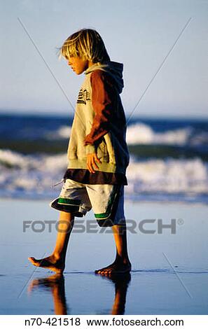 Stock Photo - Boy walking on beach. Buenos Aires. Argentina. Fotosearch