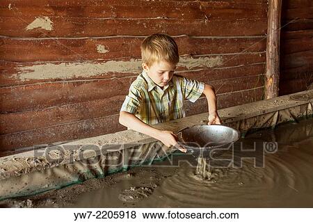 Boy washing gold in Western City - Kraina Westernu - in Sarnowa Gora, Poland. View Large Photo Image Stock Photo - Boy washing gold in Western City - Kraina Westernu - in Sarnowa Gora, Poland.. Fotosearch