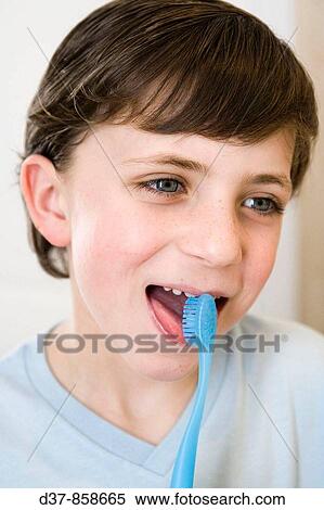 Stock Photography - Boy washing his teeth with toothbrush. Fotosearch