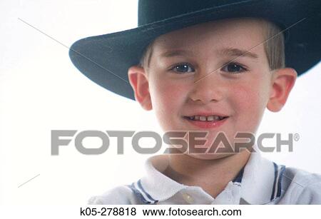 Boy wearing large black cowboy hat View Large Photo Image Stock Photo - Boy wearing large black cowboy hat. Fotosearch