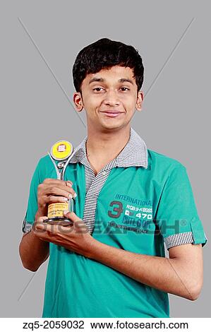 Stock Image - Boy winning prize. Boy with award.. Fotosearch