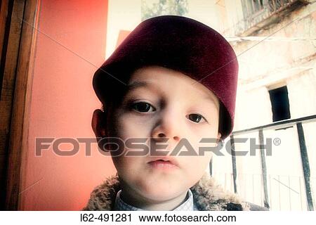 Boy with a cap. View Large Photo Image Stock Image - Boy with a cap.. Fotosearch