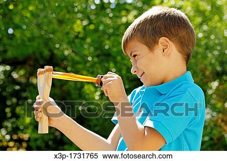 Boy with a slingshot View Large Photo Image Stock Photography - Boy with a slingshot. Fotosearch