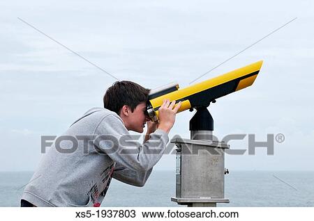 Stock Image - Boy with a telescope. Fotosearch