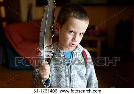 Stock Photograph - Boy with a vulture feather, Ludiente, Castello? Un, Spain. Fotosearch