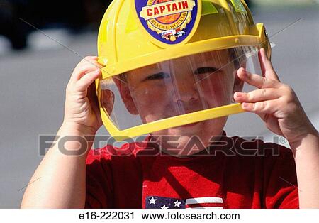 Boy with fire helmet View Large Photo Image Stock Image - Boy with fire helmet. Fotosearch