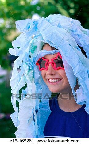Boy with glasses and paper on head View Large Photo Image Stock Image - Boy with glasses and paper on head. Fotosearch