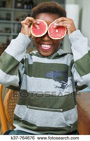 Boy with grapefruit slices over his eyes View Large Photo Image Stock Photograph - Boy with grapefruit slices over his eyes. Fotosearch