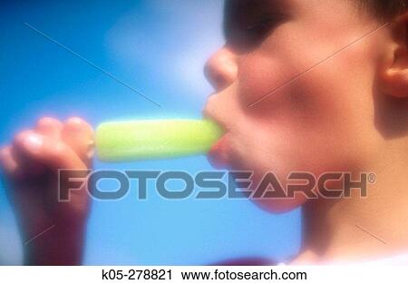 Boy with green popsicle in mouth View Large Photo Image Stock Image - Boy with green popsicle in mouth. Fotosearch