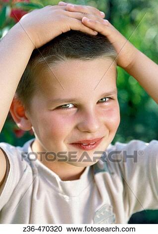 Stock Image - Boy with hands on head. Fotosearch