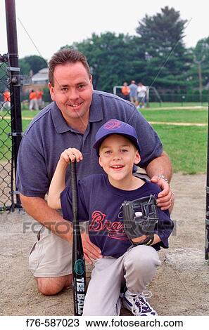 Boy with his dad at little league baseball game. View Large Photo Image Stock Image - Boy with his dad at little league baseball game.. Fotosearch