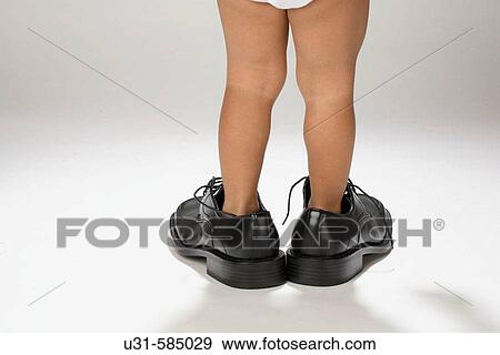 Boy with his father's shoes. View Large Photo Image Stock Photo - Boy with his father's shoes.. Fotosearch