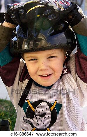 Stock Photo - boy with hockey helmet. Fotosearch