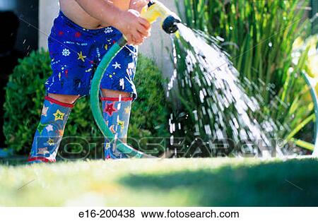 Boy with hose View Large Photo Image Stock Photo - Boy with hose. Fotosearch