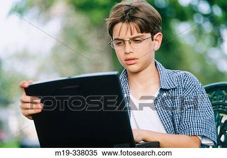 Stock Photography - Boy with laptop. Fotosearch