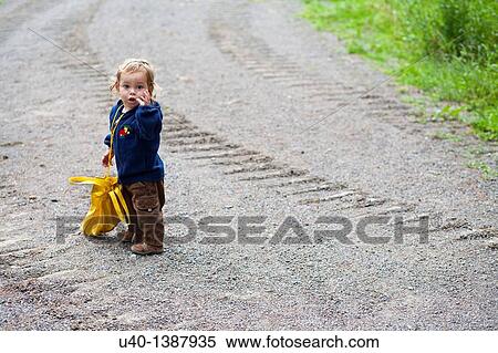 Stock Photography - Boy with large bag. Fotosearch
