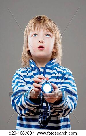 boy with long blond hair playing with flashlight View Large Photo Image Stock Photo - boy with long blond hair playing with flashlight. Fotosearch