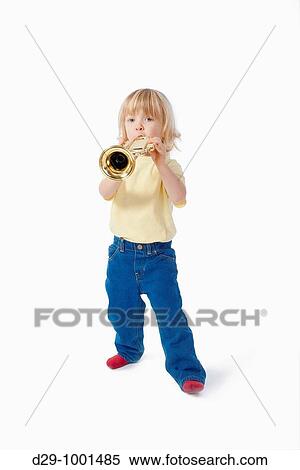 Stock Photography - boy with long blond hair playing with toy trumpet. Fotosearch