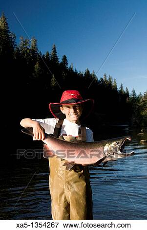 Boy with recently caught Silver Salmon, Shrode Lake, Prince William Sound, Alaska, USA View Large Photo Image Stock Photo - Boy with recently caught Silver Salmon, Shrode Lake, Prince William Sound, Alaska, USA. Fotosearch