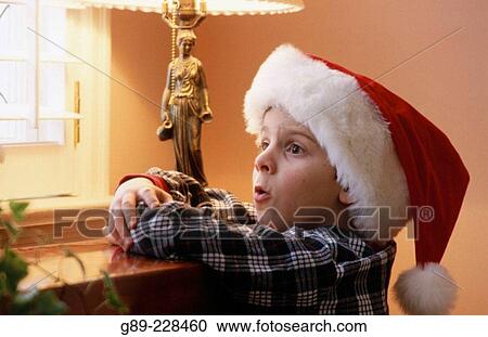 Stock Image - Boy with Santa Claus? hat. Fotosearch