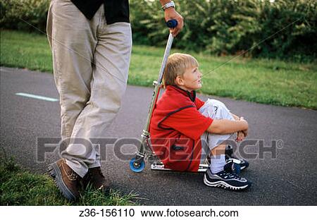Boy with scooter View Large Photo Image Stock Image - Boy with scooter. Fotosearch