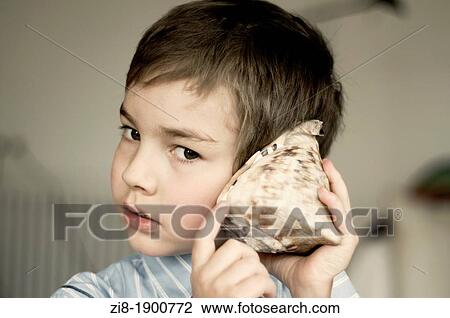 Boy with seashell View Large Photo Image Stock Image - Boy with seashell. Fotosearch