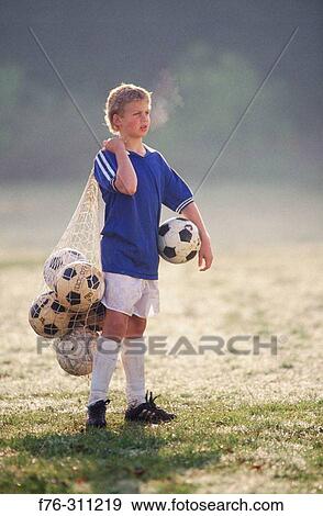Stock Photo - Boy with soccer balls. Fotosearch