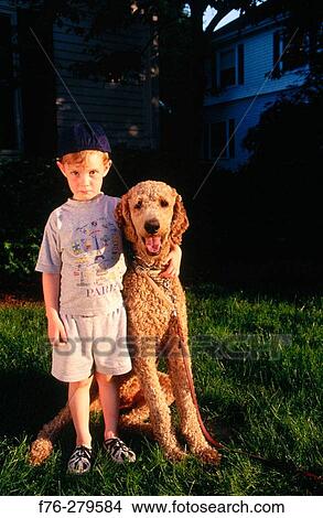 Picture - Boy with standard poodle. Fotosearch