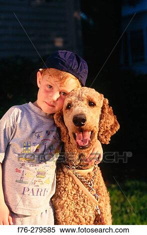 Stock Photography - Boy with standard poodle. Fotosearch
