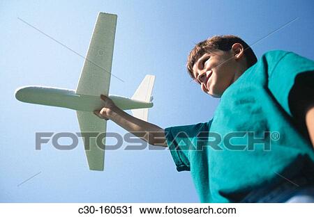 Boy with toy airplane View Large Photo Image Stock Image - Boy with toy airplane. Fotosearch
