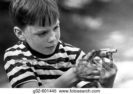 Stock Photography - Boy with toy pistol. Fotosearch