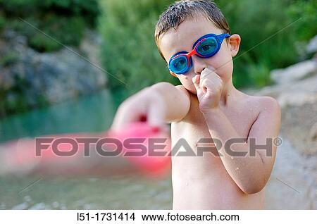 Picture - boy with underwater glasses playing by the river, Villahermosa river, Ludiente, Castell? n, Spain. Fotosearch
