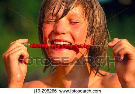 Boy with wild strawberries on a straw in Swedish summer View Large Photo Image Stock Photograph - Boy with wild strawberries on a straw in Swedish summer. Fotosearch
