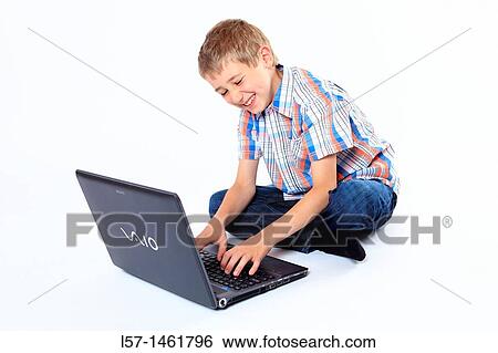 Boy working on laptop computer, Switzerland View Large Photo Image Stock Photograph - Boy working on laptop computer, Switzerland. Fotosearch