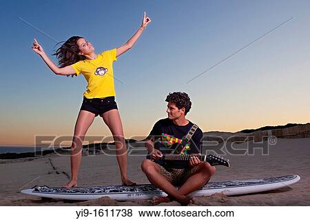 Stock Photo - boyfriends singing and dancing with guitar. Fotosearch