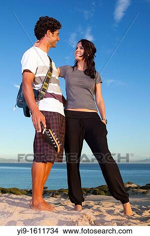 boyfriends with a guitar playing on the beach View Large Photo Image Picture - boyfriends with a guitar playing on the beach. Fotosearch
