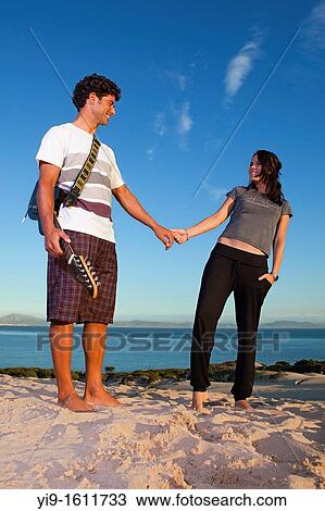 boyfriends with a guitar playing on the beach View Large Photo Image Stock Image - boyfriends with a guitar playing on the beach. Fotosearch