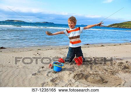 boyl playing on sandy beach, Sutherland, Scotland View Large Photo Image Stock Photography - boyl playing on sandy beach, Sutherland, Scotland. Fotosearch