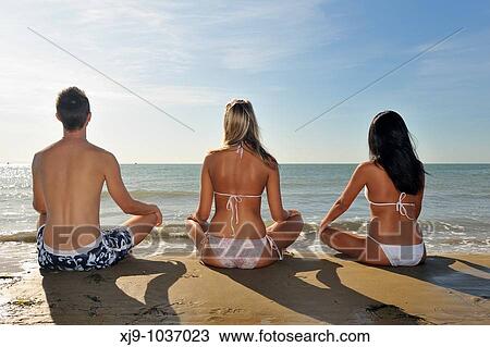 Boys and girls sitting in front of the sea that are meditation and yoga View Large Photo Image Stock Image - Boys and girls sitting in front of the sea that are meditation and yoga. Fotosearch