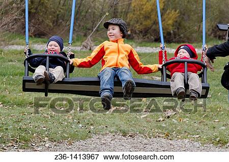 Stock Photo - Boys at seesaw. Fotosearch
