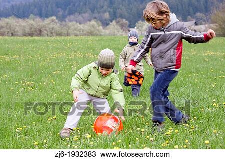 Boys chasing ball. Slovenia Europe. View Large Photo Image Stock Image - Boys chasing ball. Slovenia Europe.. Fotosearch