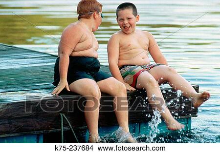 Boys enjoying splashing in a lake View Large Photo Image Picture - Boys enjoying splashing in a lake. Fotosearch