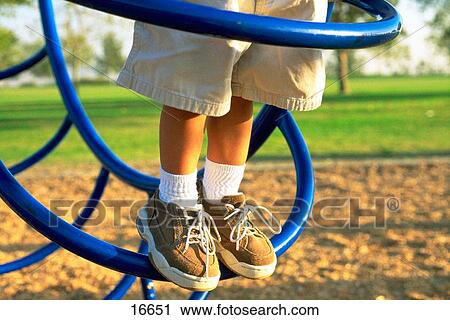Boy's feet on playground bars View Large Photo Image Stock Image - Boy's feet on playground bars. Fotosearch