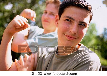 Stock Image - Boys flexing muscles. Fotosearch