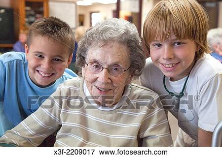 Boys having a fun time with their Great grandmother ages 8, 96 and 11. Battle Lake Minnesota MN USA. View Large Photo Image Stock Photo - Boys having a fun time with their Great grandmother ages 8, 96 and 11. Battle Lake Minnesota MN USA.. Fotosearch