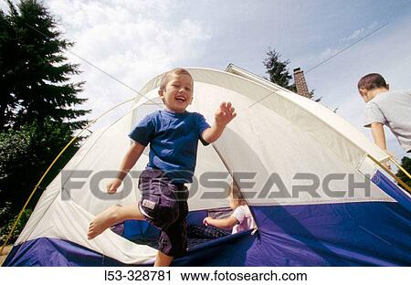 Stock Image - Boys in tent.. Fotosearch