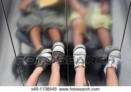 Stock Photo - Boy's legs in elevator, detail. Fotosearch