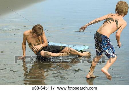 boys mud throwing in Osa Penisula, Costa Rica View Large Photo Image Stock Photo - boys mud throwing in Osa Penisula, Costa Rica. Fotosearch