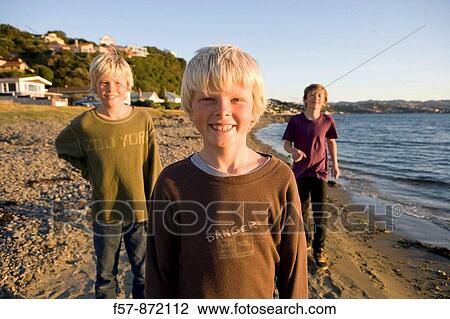 Boys on Plimmerton beach, New Zealand View Large Photo Image Stock Image - Boys on Plimmerton beach, New Zealand. Fotosearch