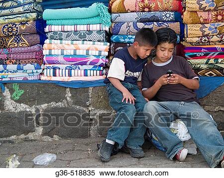 Boys play with cell phone in market in Solola, Guatemala View Large Photo Image Stock Photography - Boys play with cell phone in market in Solola, Guatemala. Fotosearch